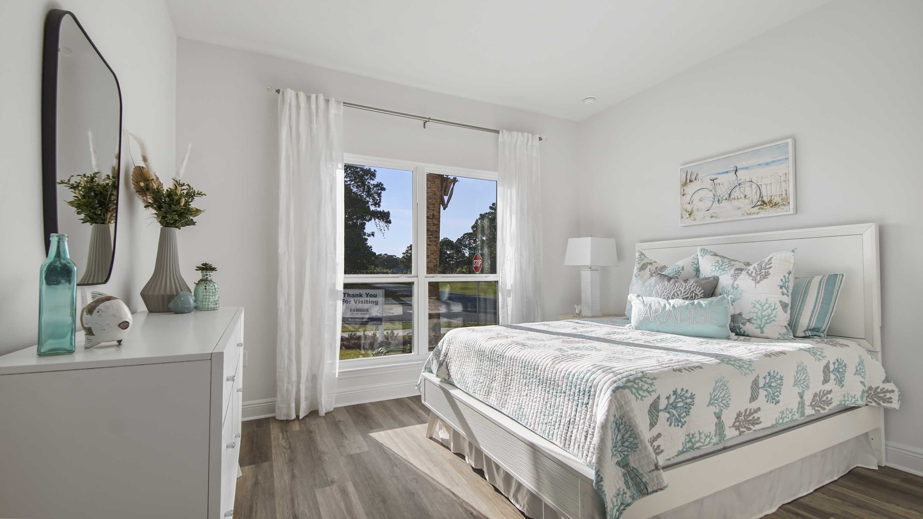 Bedroom five in front of the house with large picture window and EVP flooring.