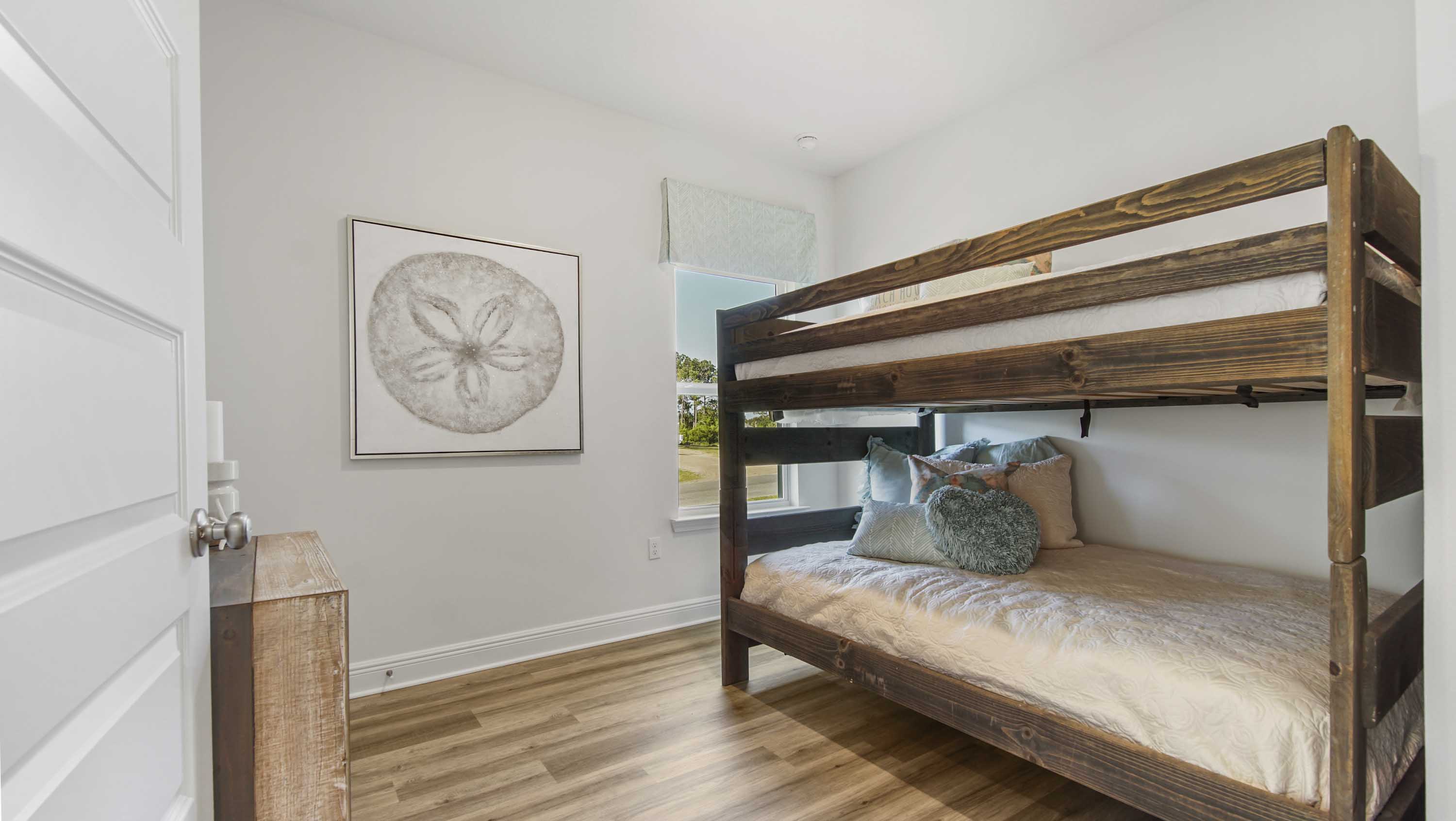 Bedroom three with EVP flooring and window.