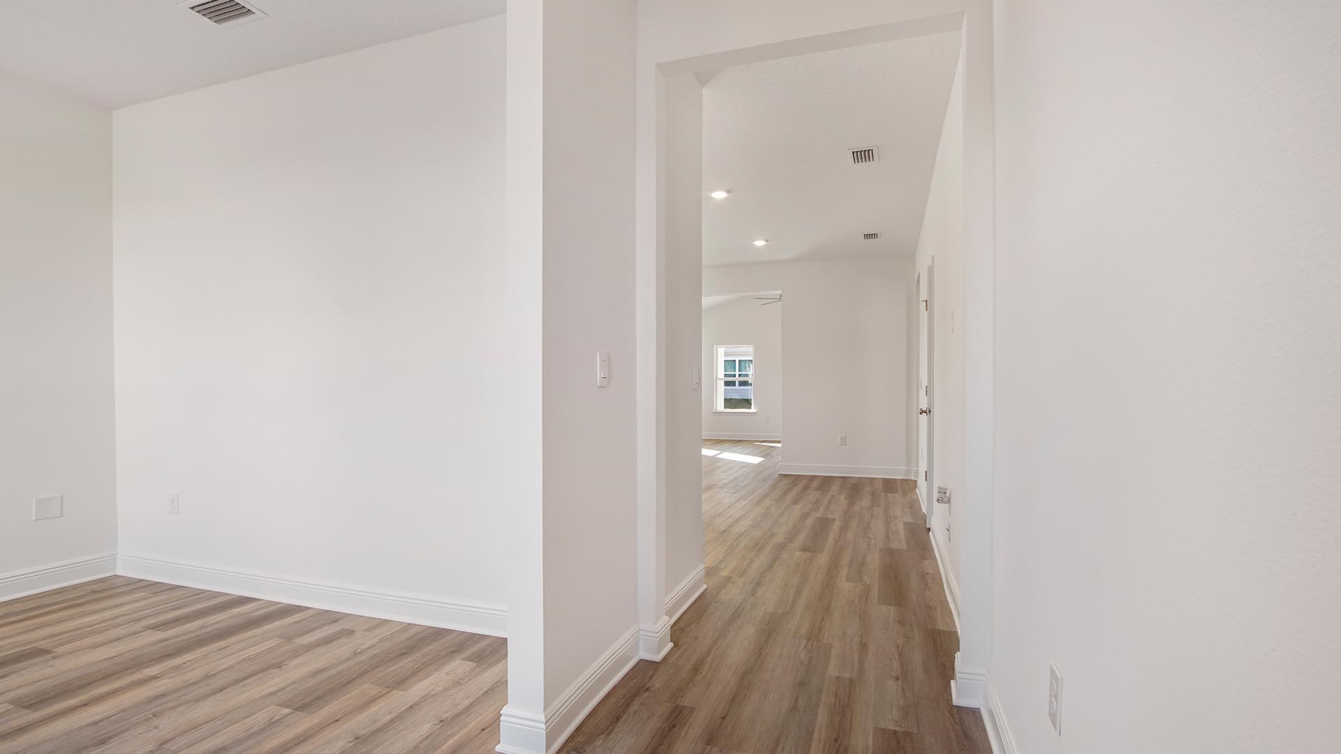 Foyer with EVP flooring and flex space for an office or formal dining room.