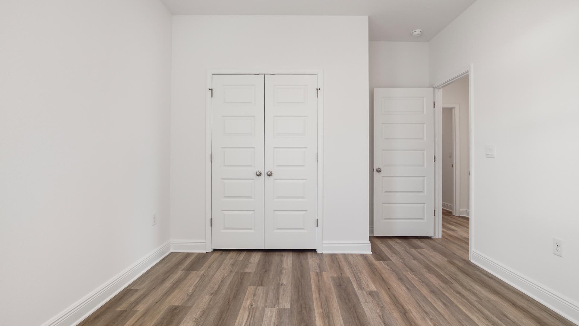 Bedroom three with EVP floor and closet