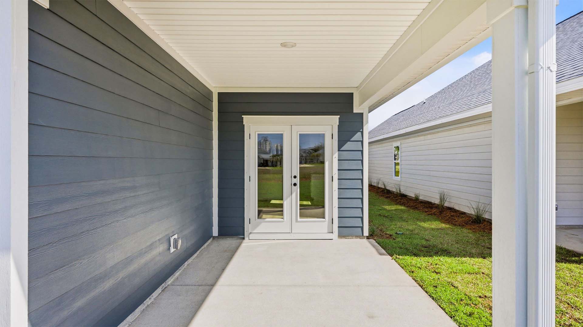 The covered patio has space for a dining area or lounge chairs
