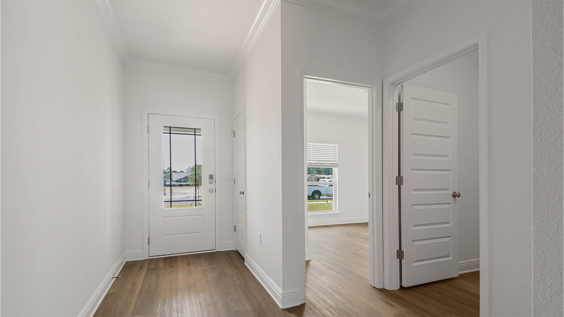 Front door entrance in foyer by bedroom and bathroom.
