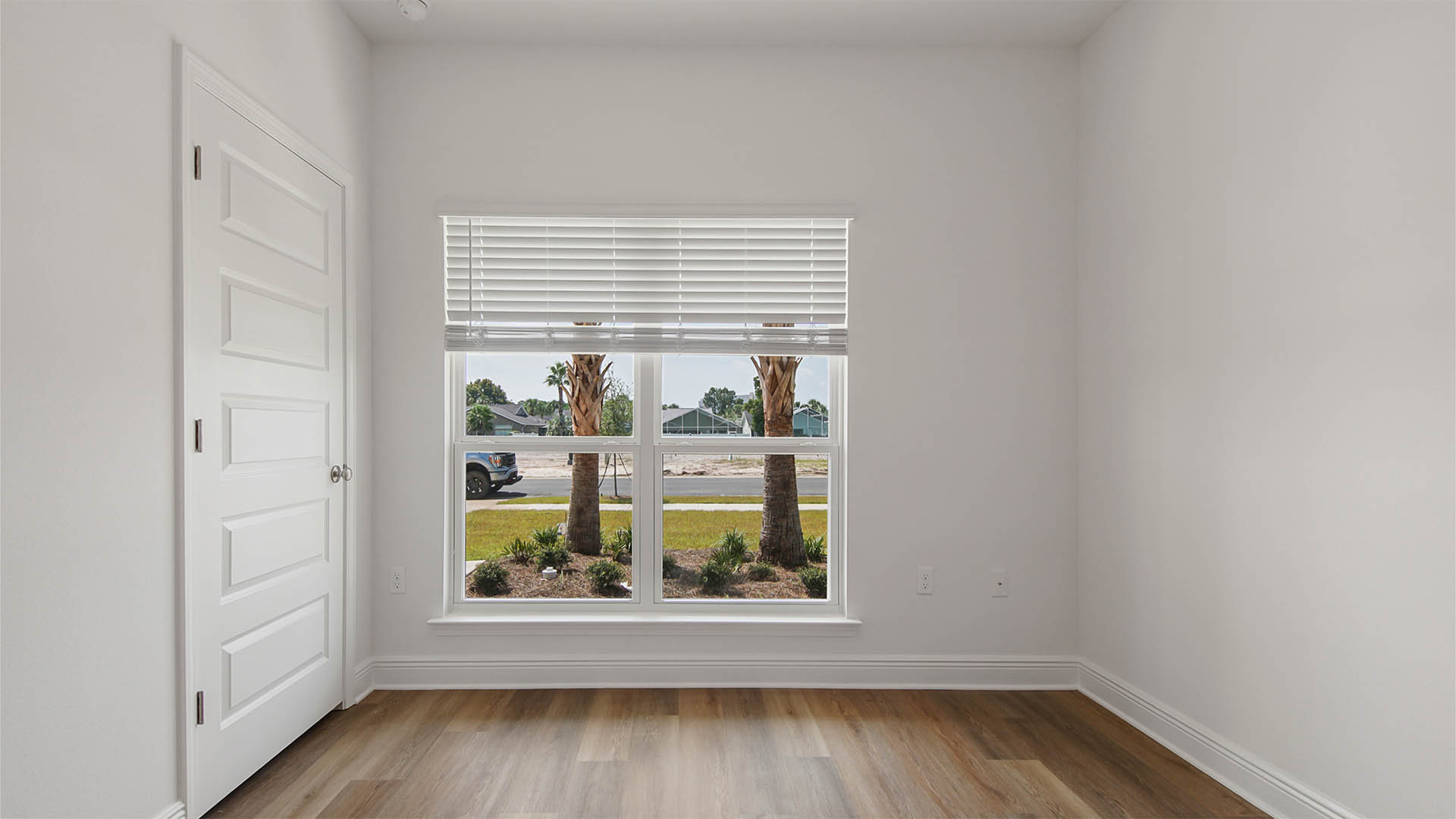 Bedroom two with EVP flooring and large window and closet.