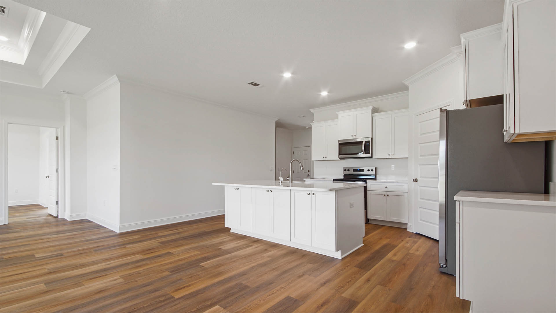 Opening living are with kitchen and dining room and living room with EVP flooring.