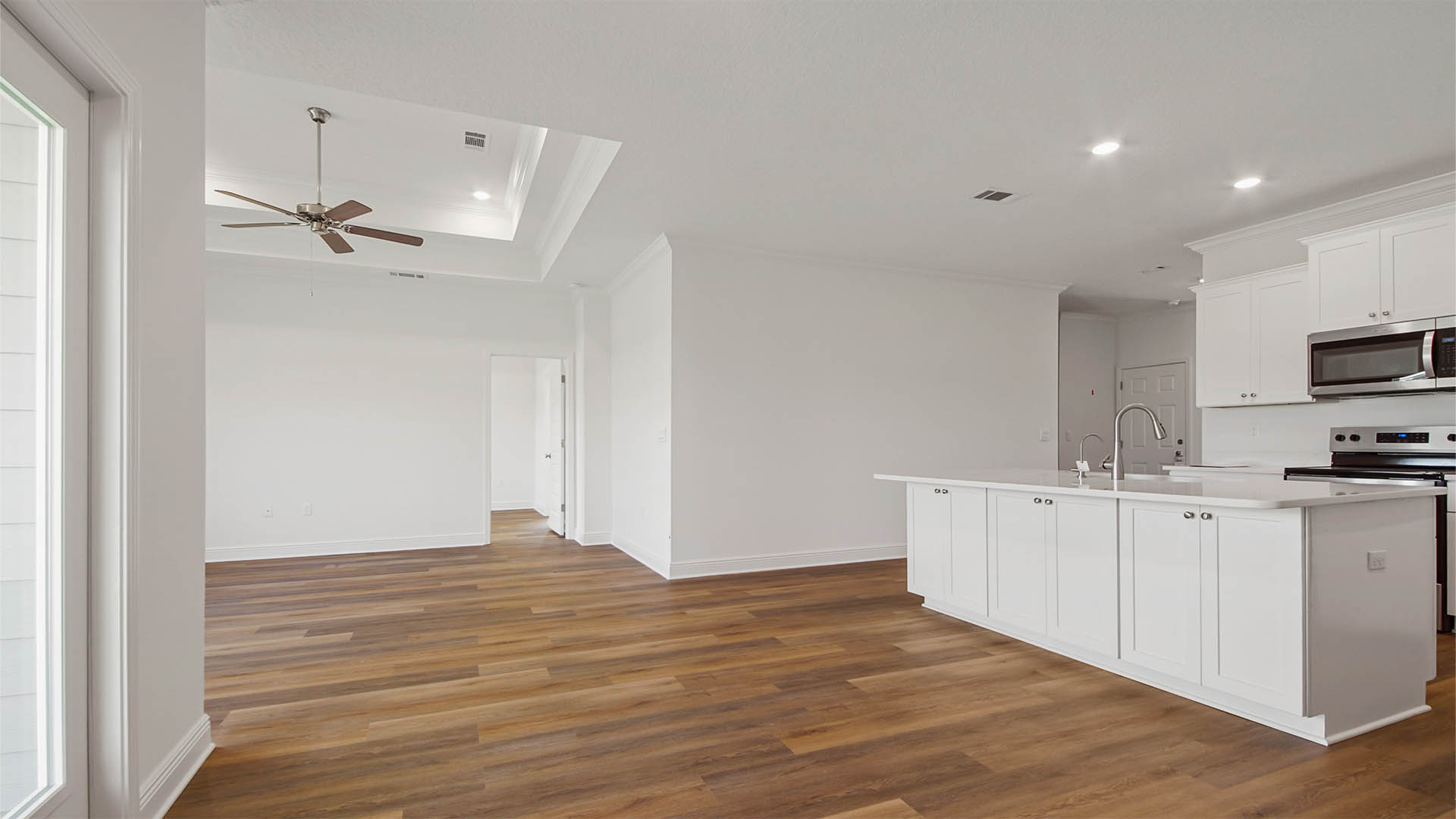 Opening living are with kitchen and dining room and living room with EVP flooring.