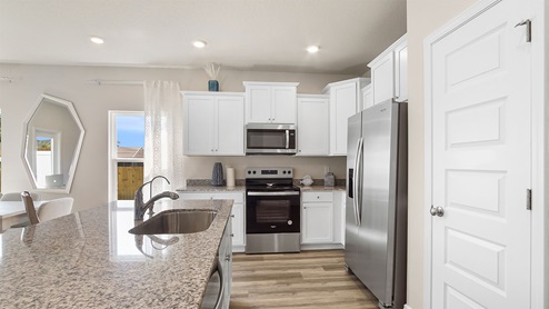 The kitchen is open to the living and dining area
