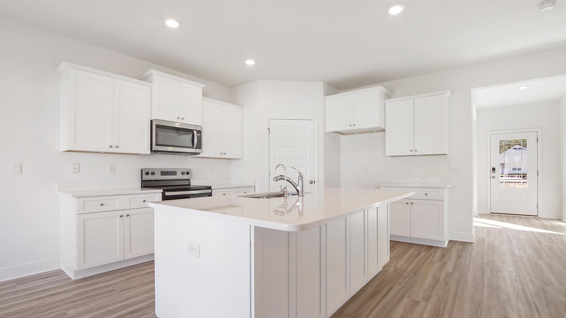 Elegant quartz countertops and island with lower cabinetry
