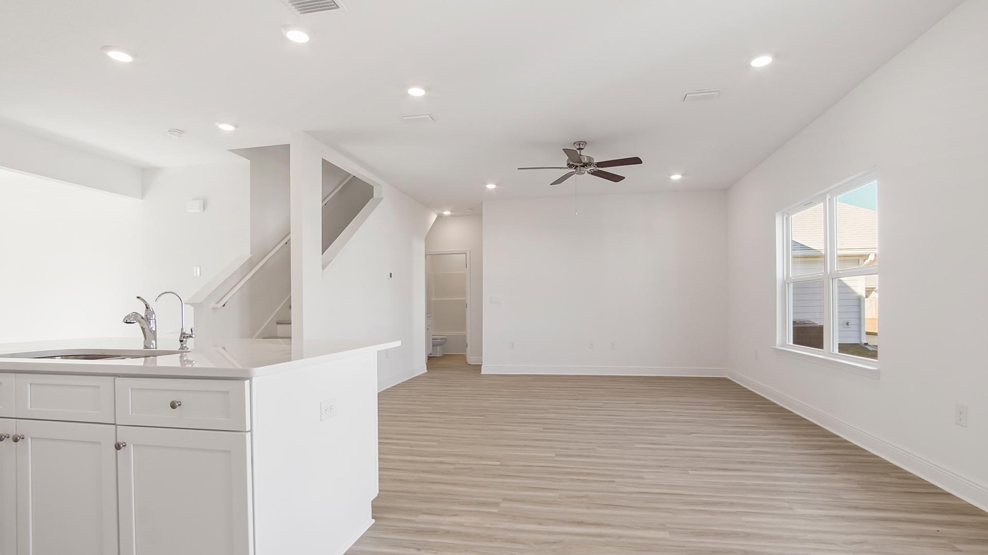 The kitchen island features a sink and stainless steel dishwasher