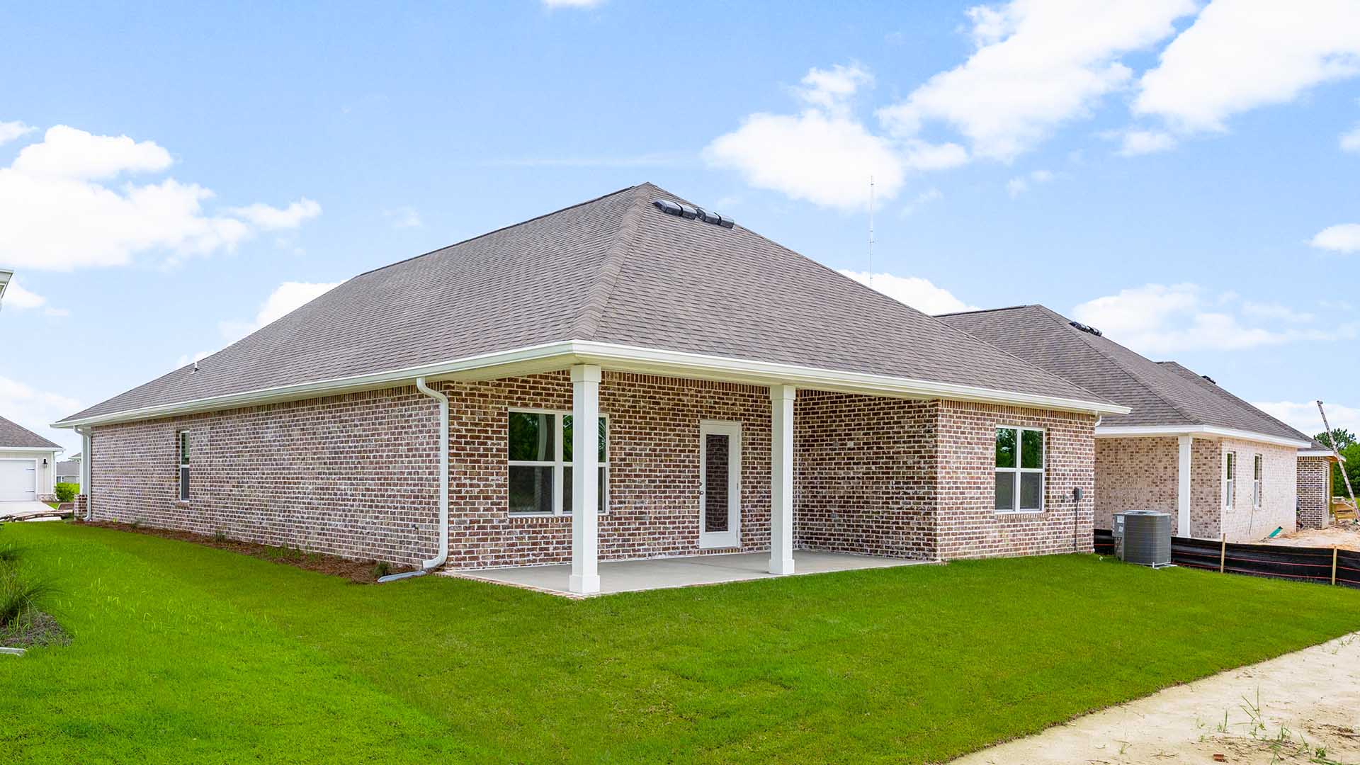 The back of the home has a covered patio