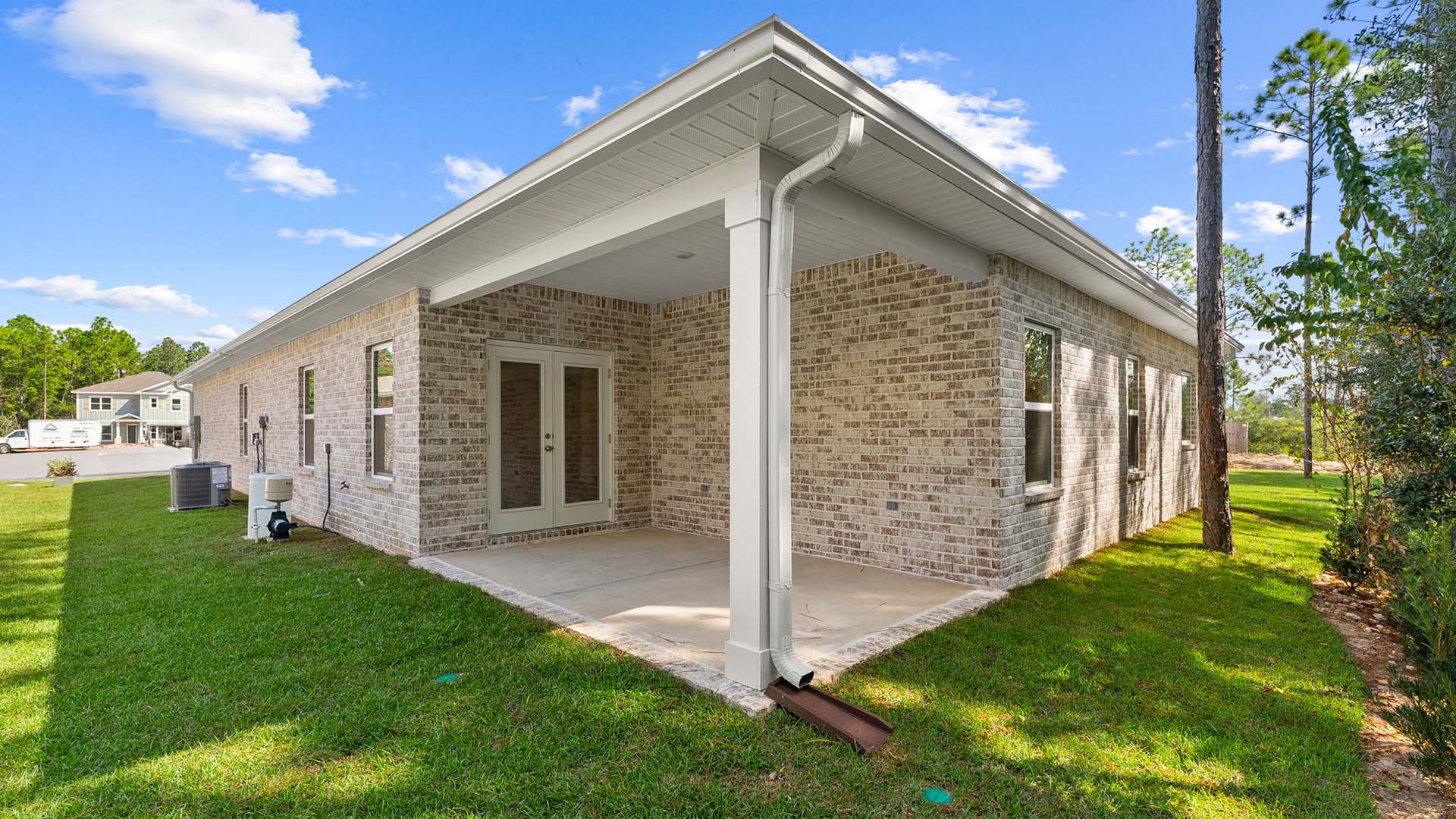 the back of the Kennedy has brick siding and a covered patio