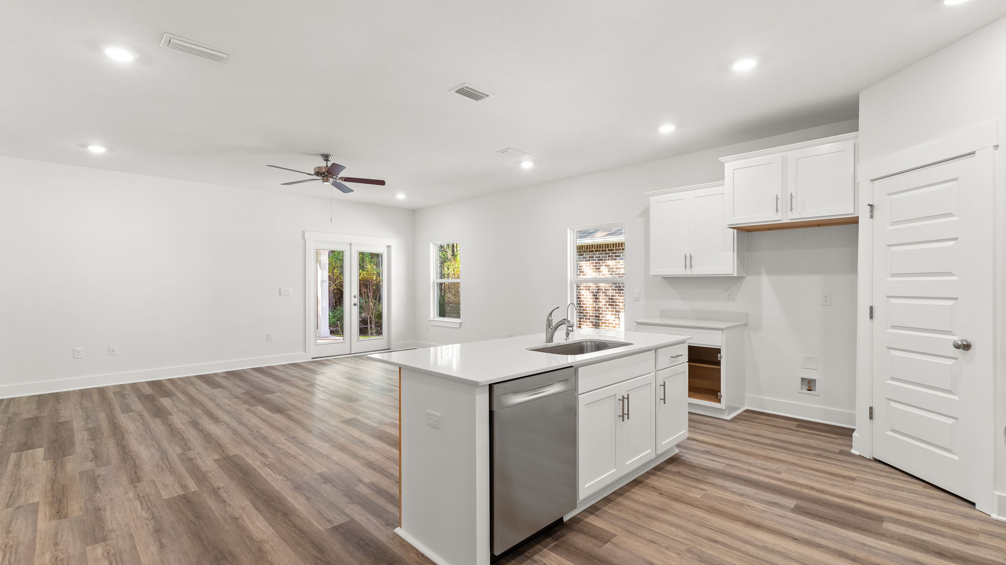 The entry hall leads to the kitchen with EVP flooring