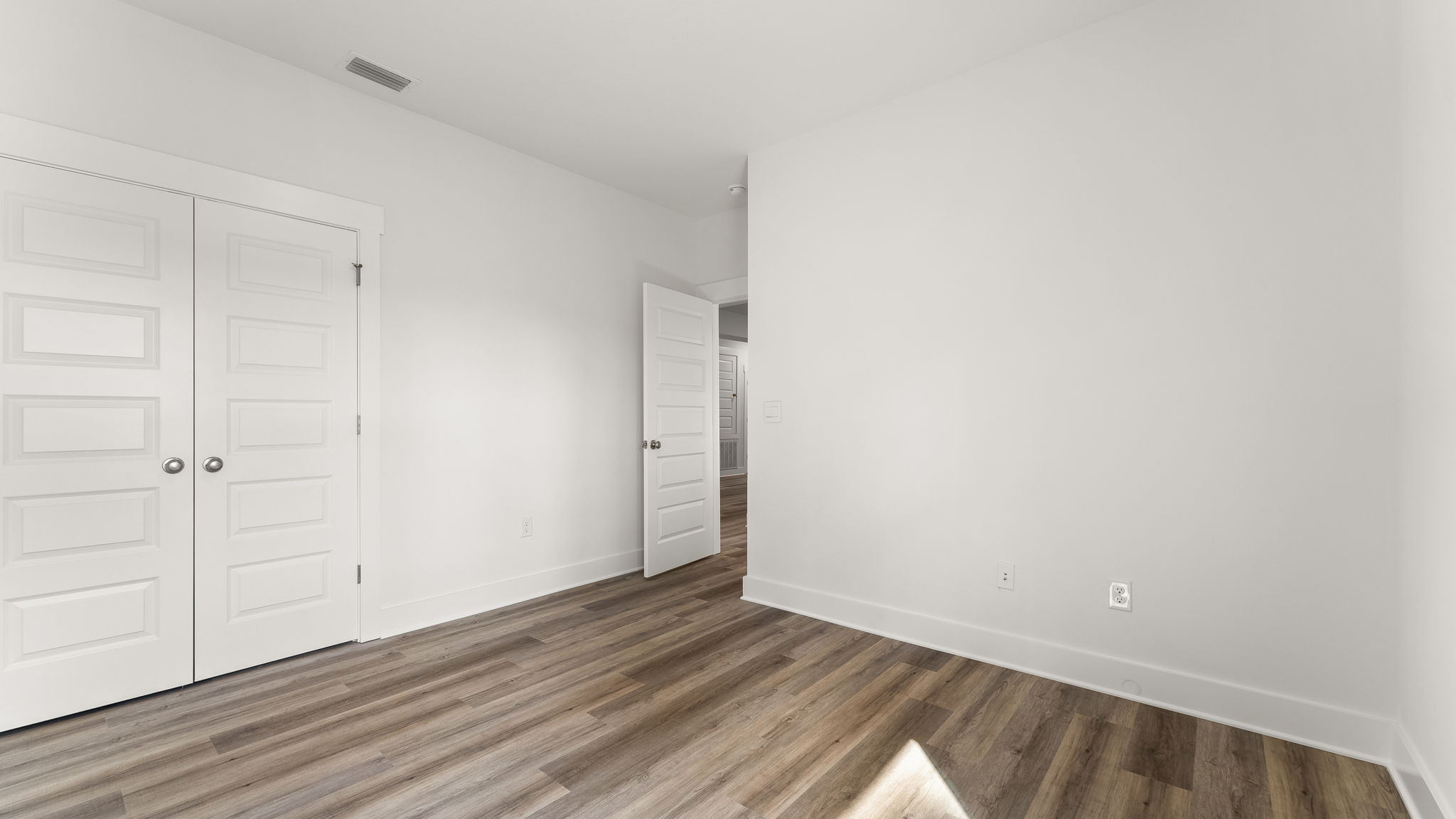 Guest bedroom one has EVP flooring