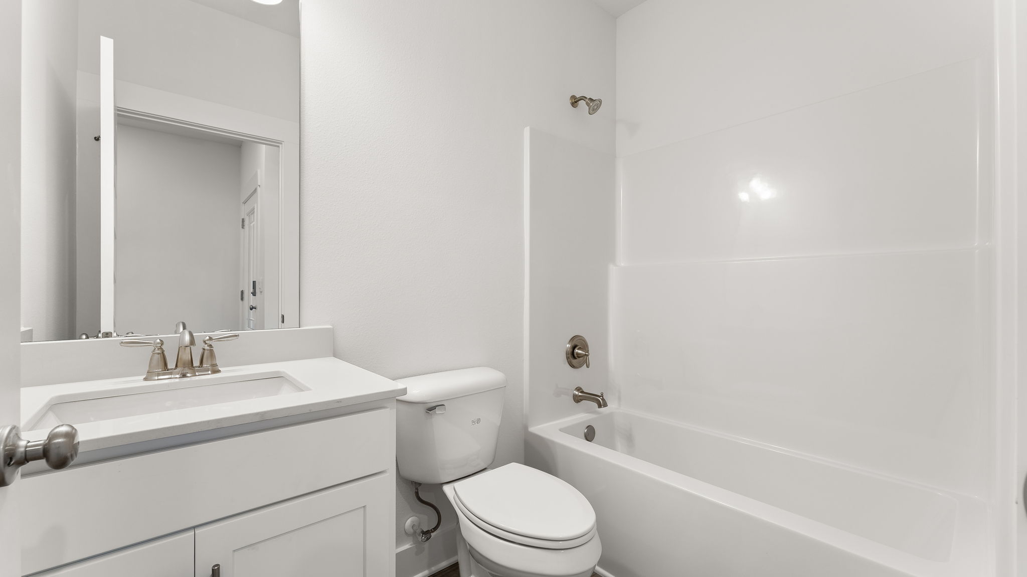 Shared bathroom two has a single vanity and a shower tub combination