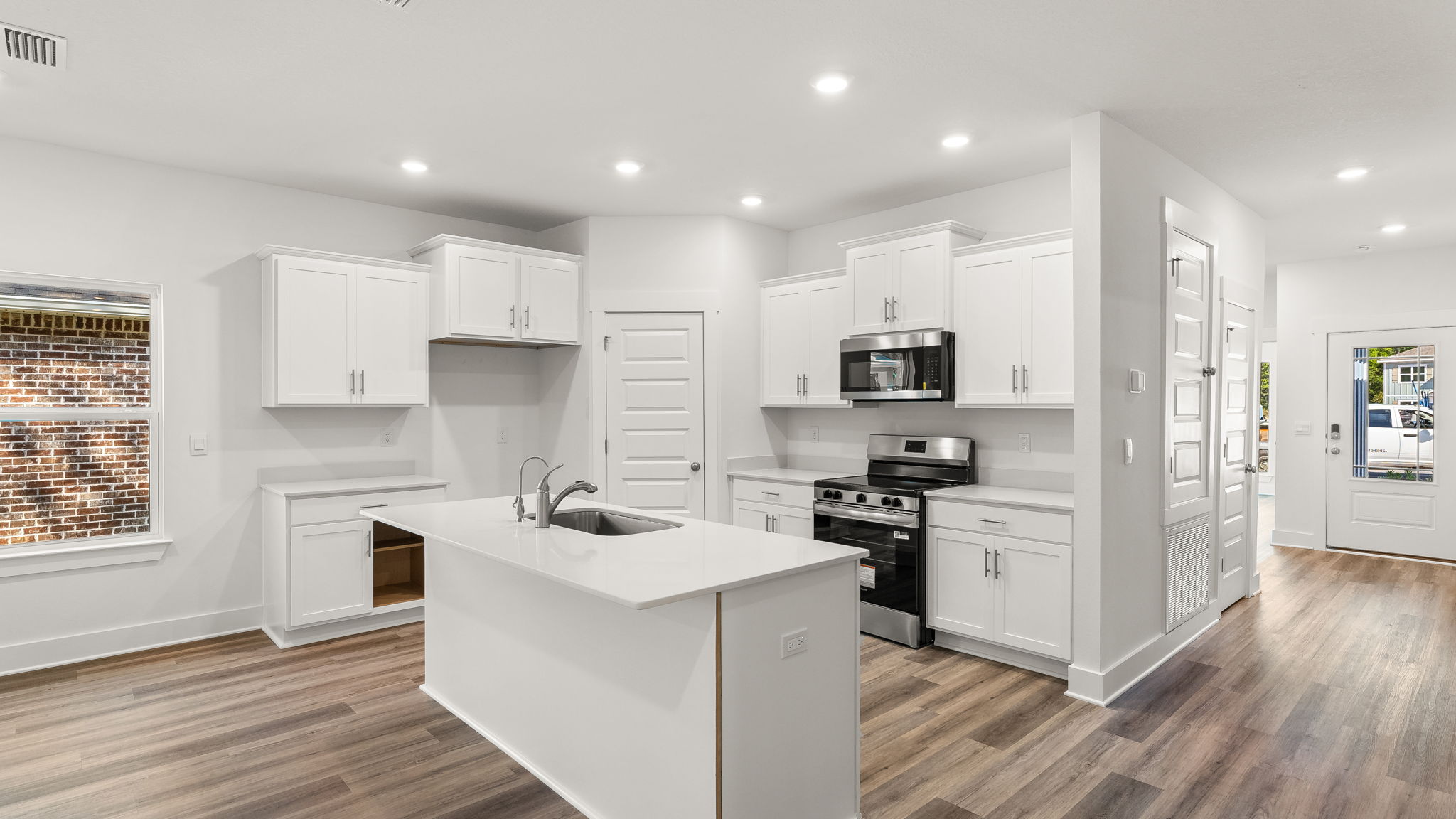 Each kitchen is designed with beautiful white cabinetry and quartz countertops