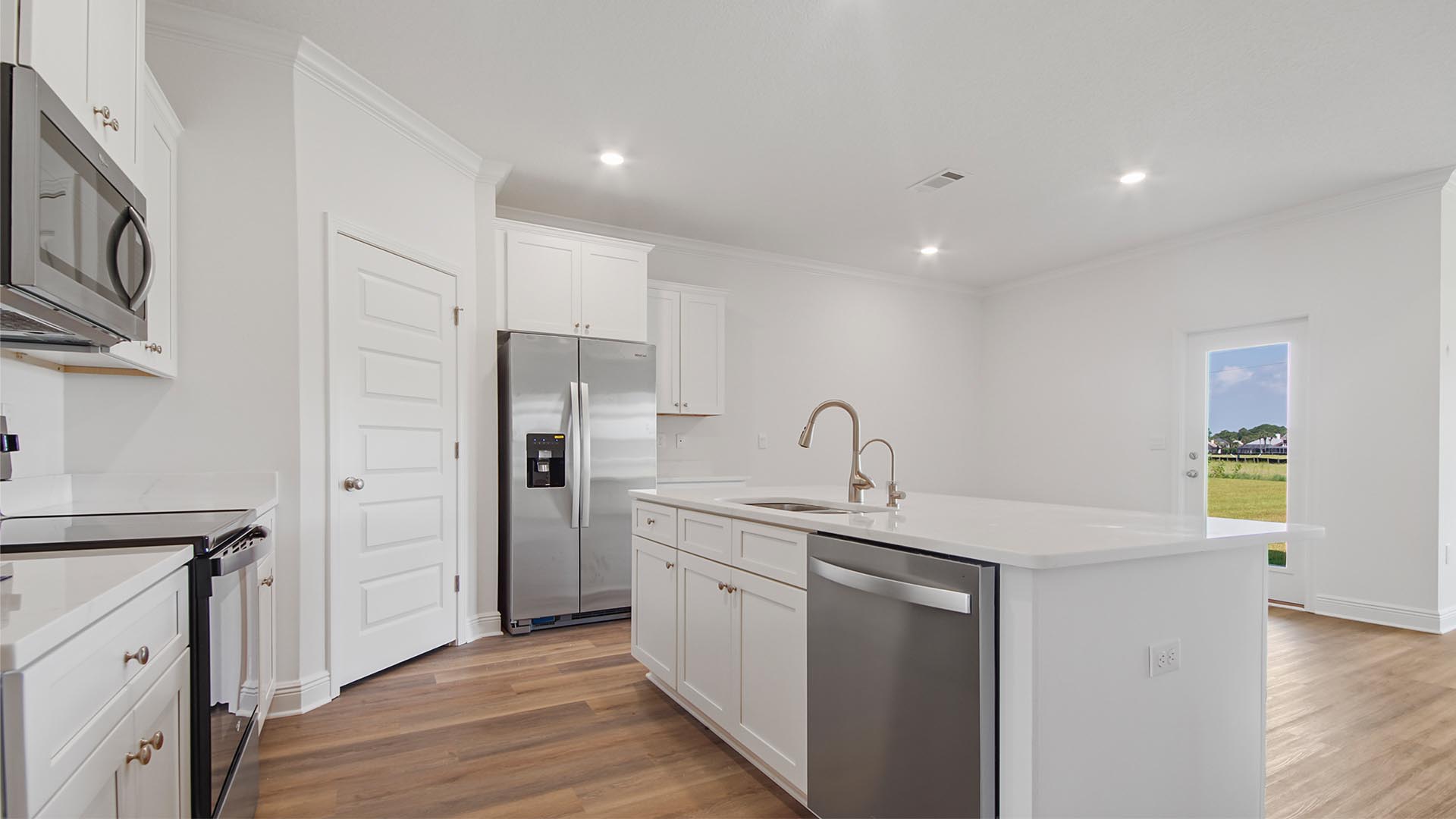 The kitchen opens to the living room and features quartz countertops