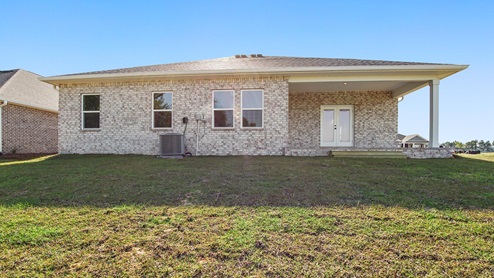 Back of the Camden with brick siding on three sides and covered patio