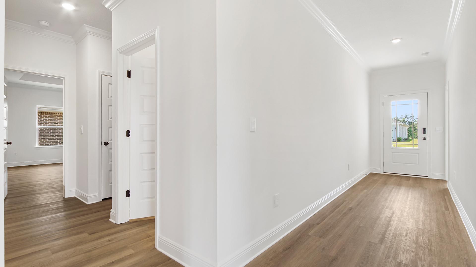 EVP Flooring in the foyer with bedrooms two and three and a shared bathroom