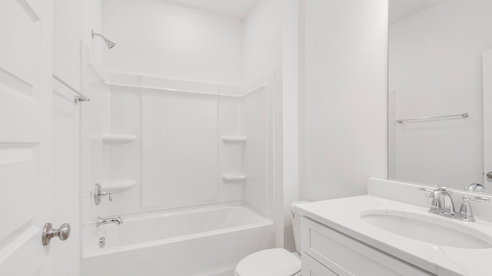 The full bathroom has a single vanity and lower cabinetry