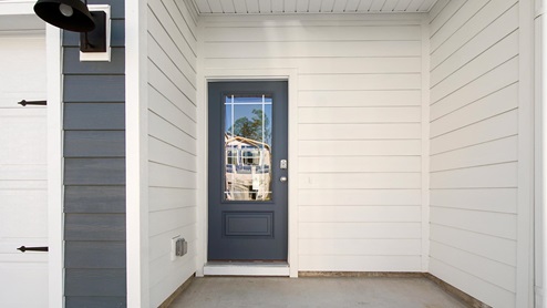 The entry to the Palm townhome unit is covered and has glass door