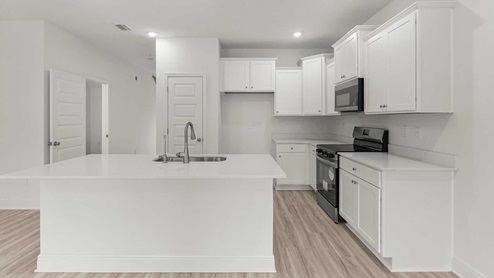 The kitchen is open to the living room and dining room and has center island