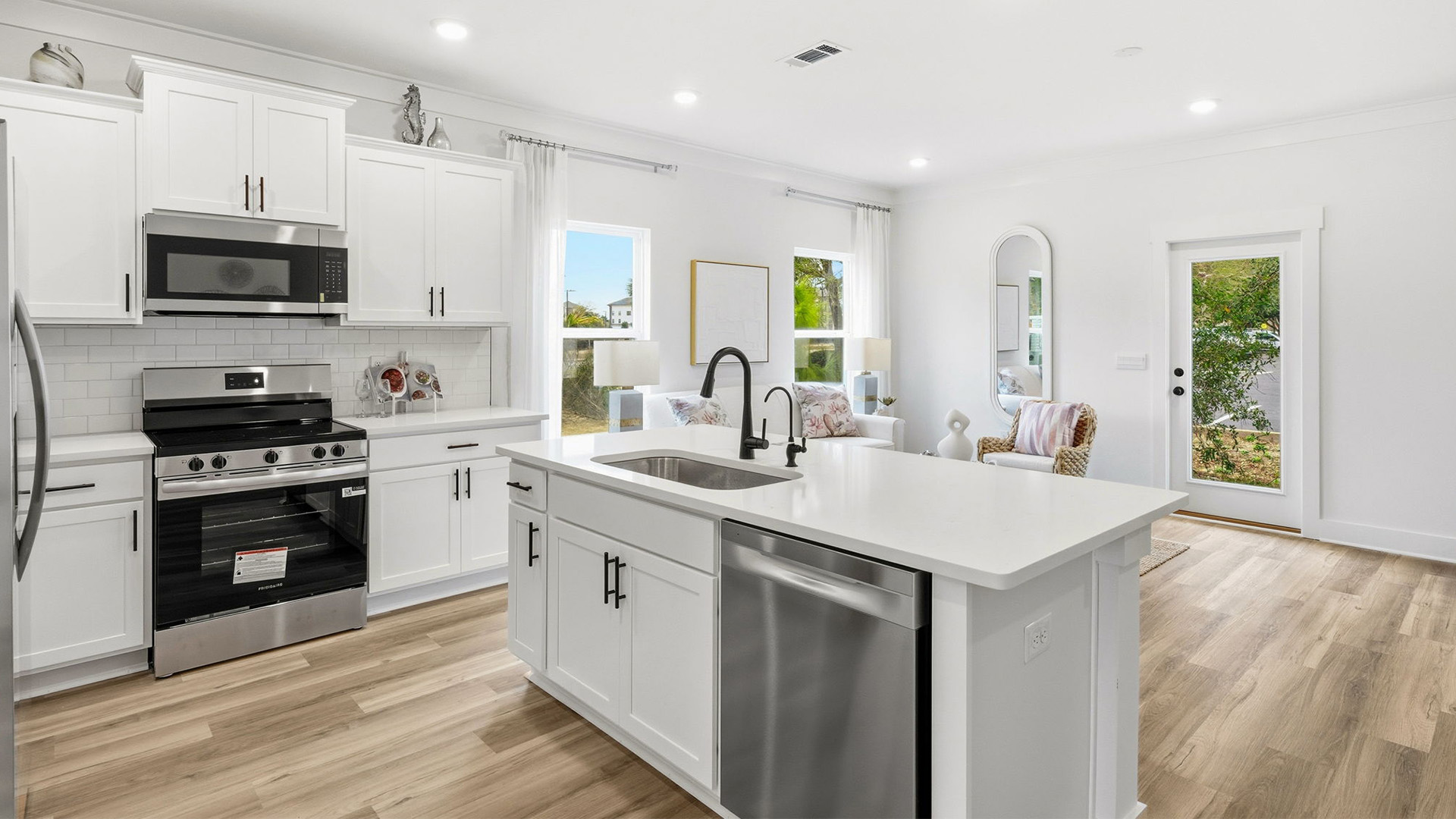 The kitchen has upper and lower cabinetry for storage