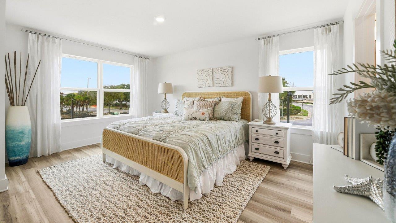 The primary bedroom is on the second level and has windows that allow natural light