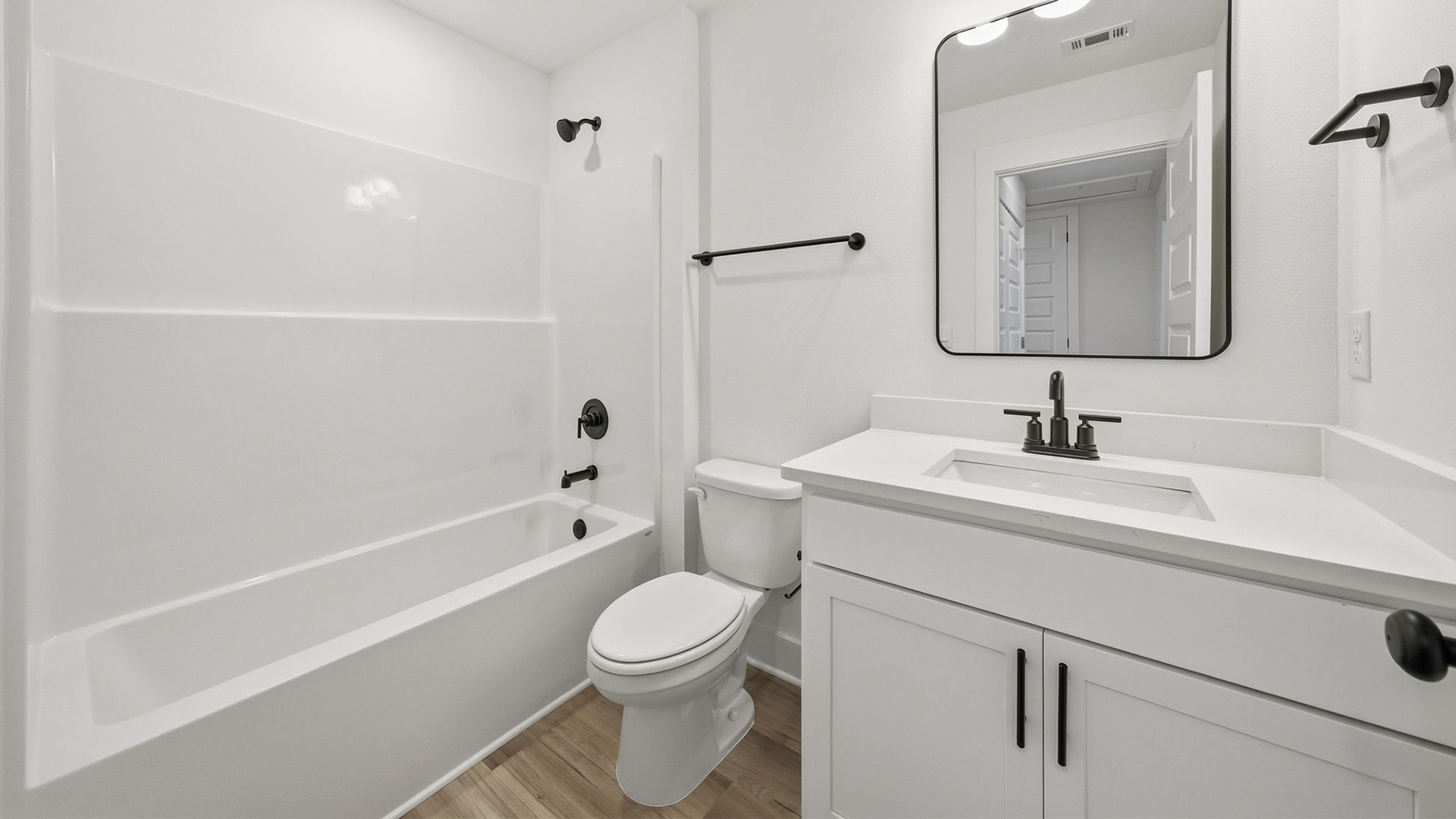 The shared bathroom has a shower tub combination