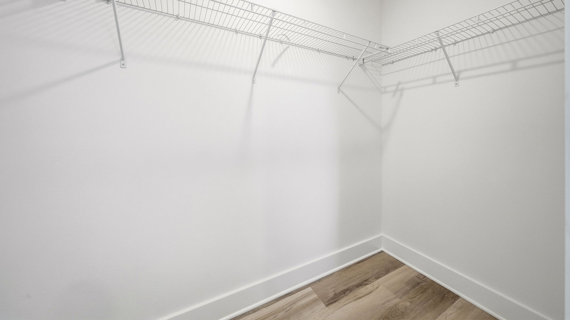 The spacious closet has upper shelving