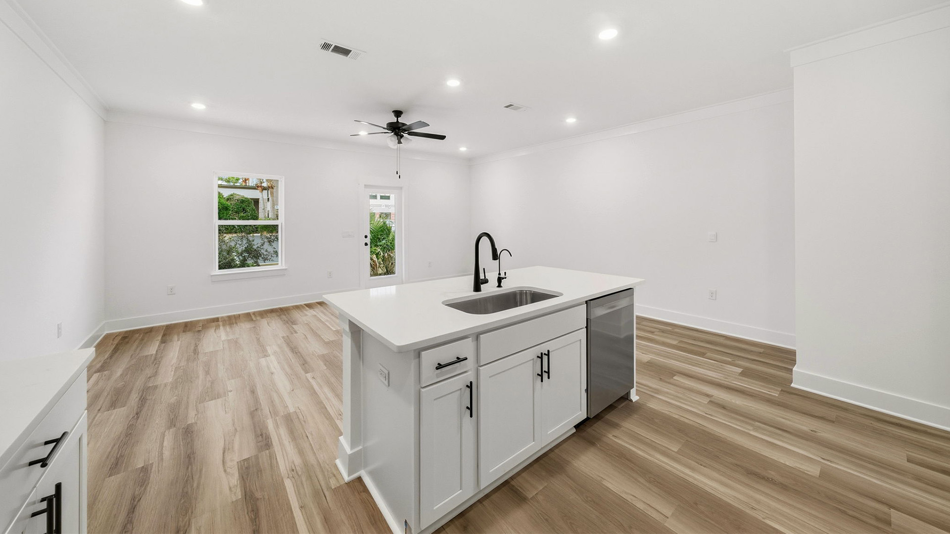 The kitchen looks out to the dining and living areas