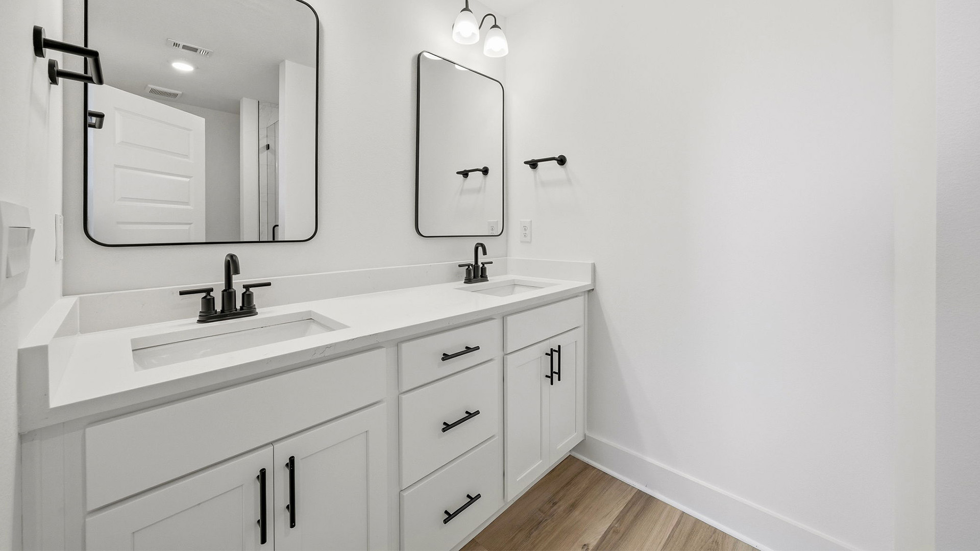 The Primary bathroom has a dual sink vanity with lower cabinetry for storage