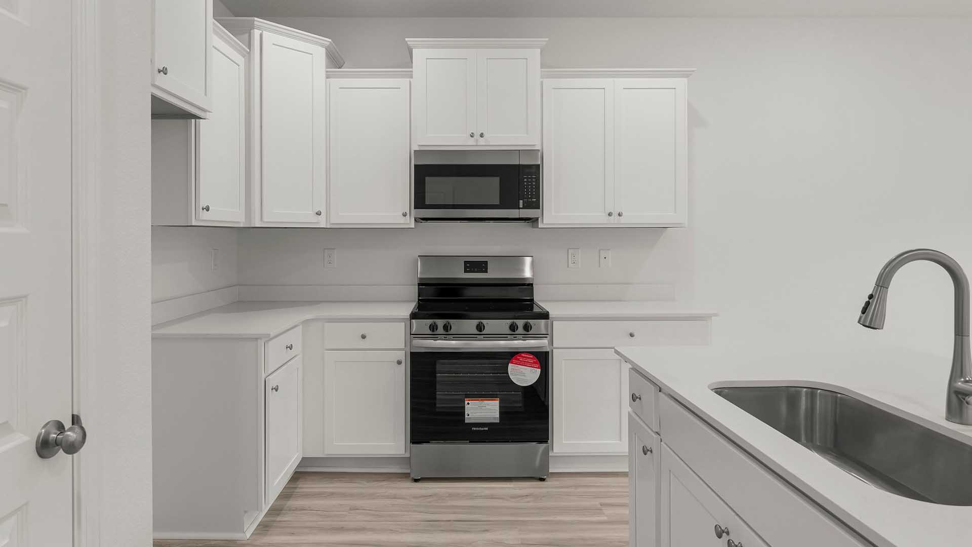 The kitchen has appliances which include a smooth top stove, microwave and dishwasher