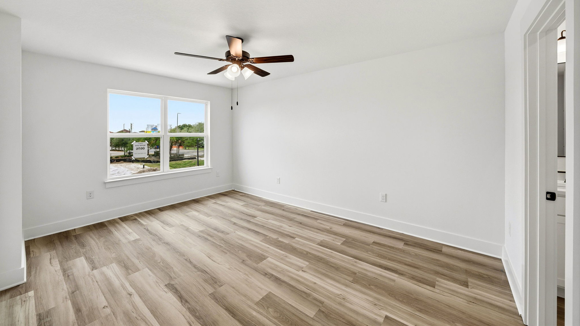 The primary bedroom has windows allowing for natural light