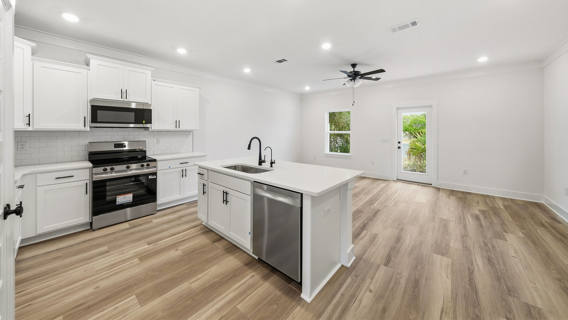 The kitchen has a center island with dishwasher and sink