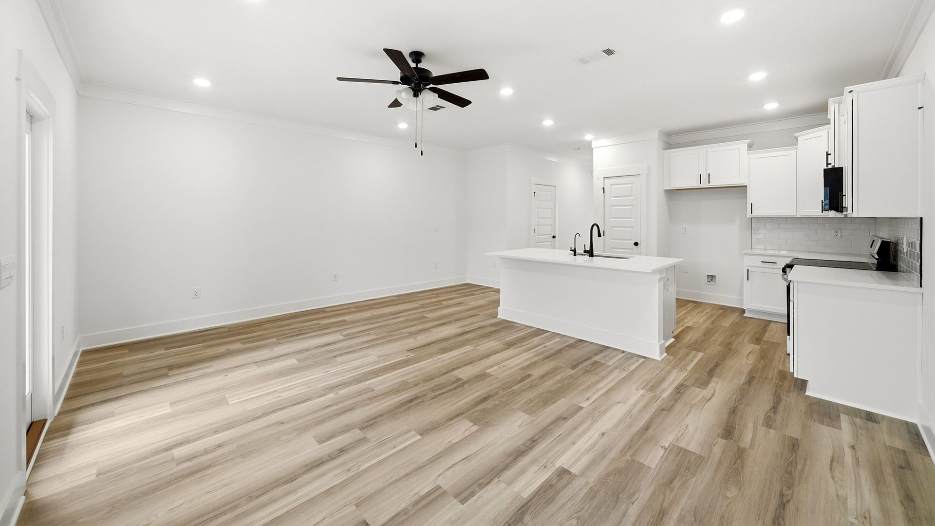 The spacious living area has space for a sofa, chairs and end tables