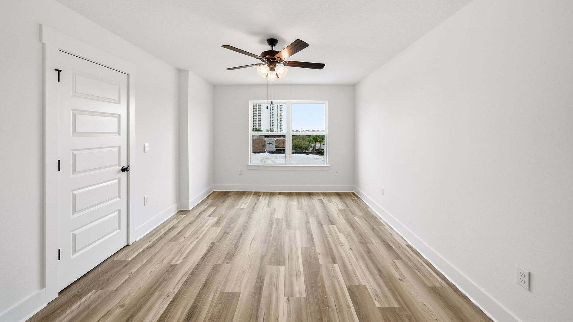 The primary bedroom has windows allowing for natural light