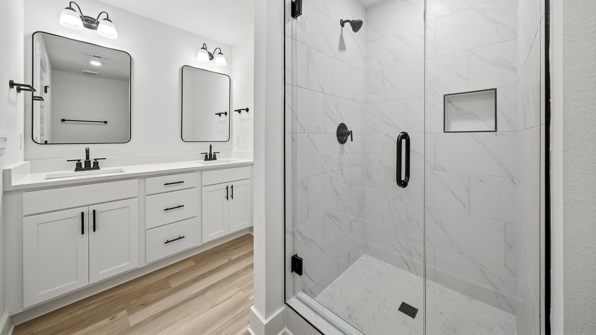 The Primary bathroom has a dual sink vanity with lower cabinetry for storage