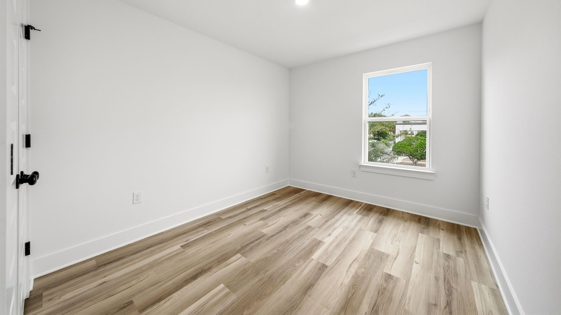 There are two guest bedrooms at the back of the townhome on the second level