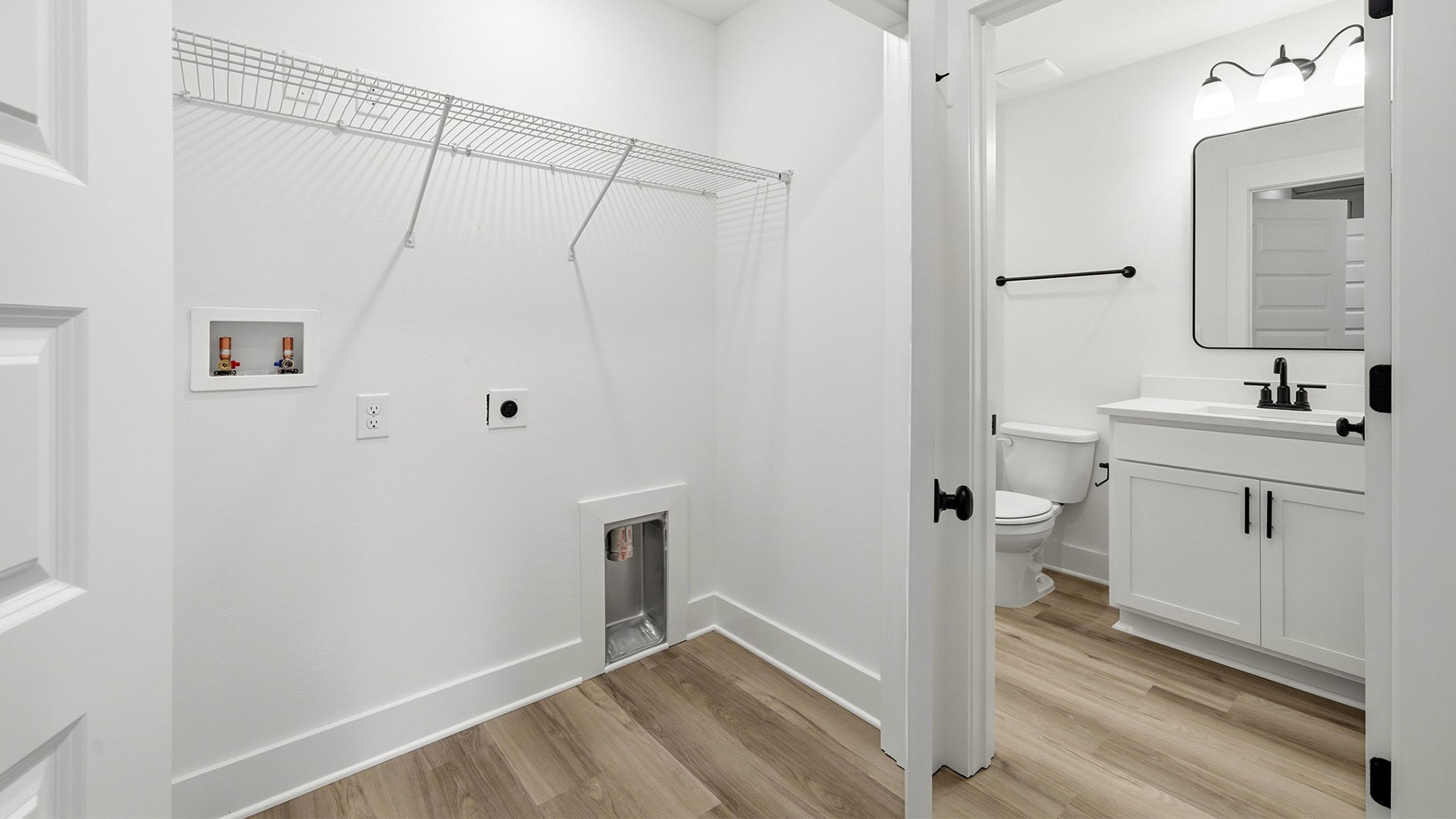The shared bathroom has single vanity with lower cabinetry for storage