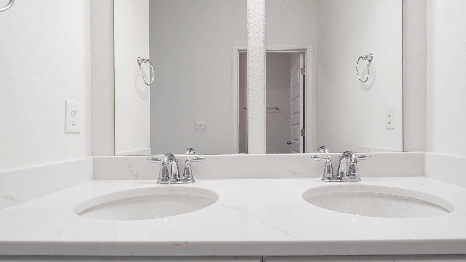 The shared bath has a dual sink vanity