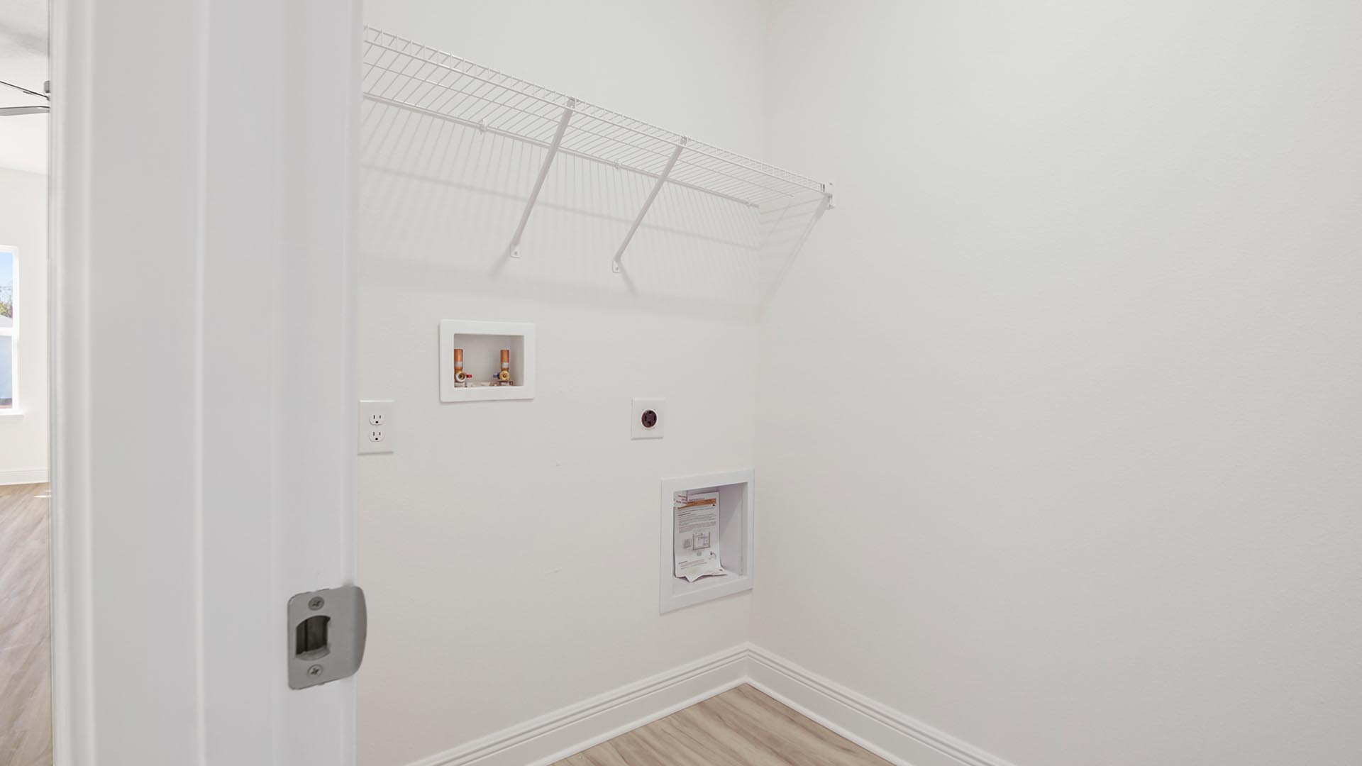 The laundry room has space for a full size washer and dryer