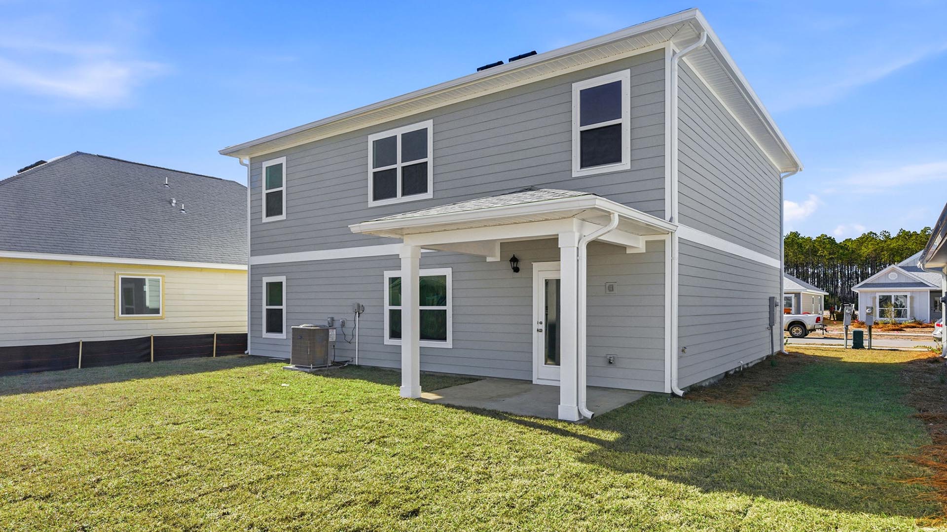A covered back patio has space for outdoor table or seating