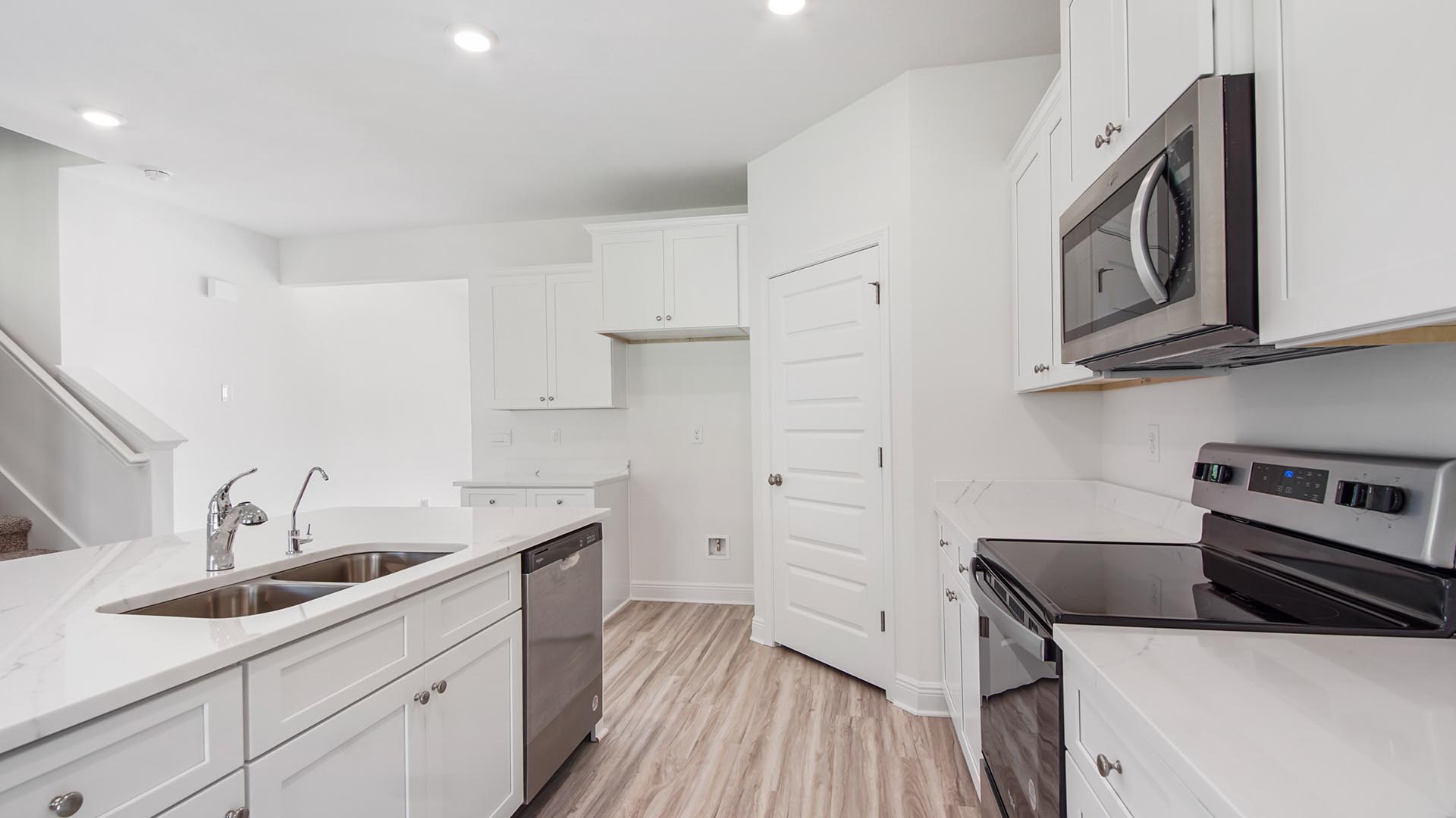 Stainless steel appliances include a smooth top stove, microwave and dishwasher