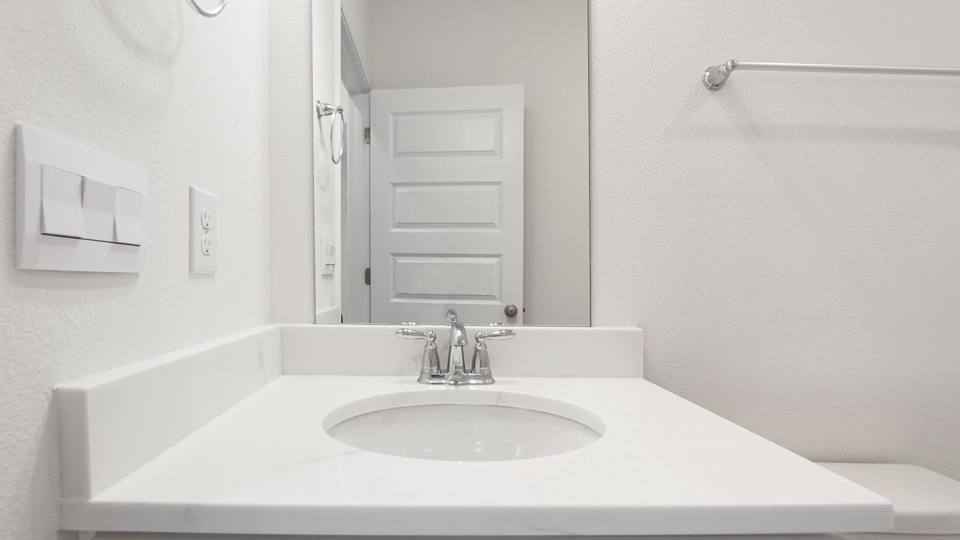 The full bathroom on the main level has single vanity with lower cabinetry for storage