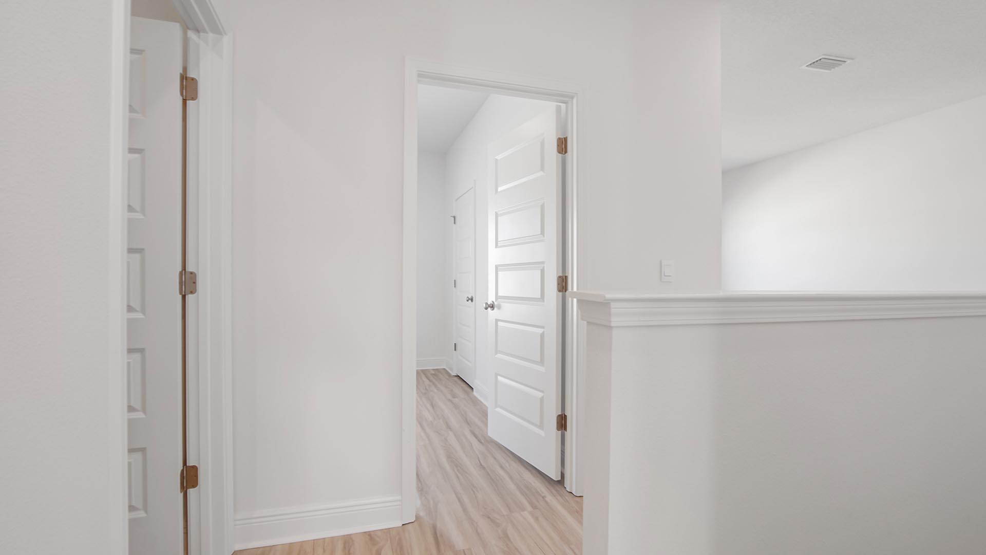 The hall leading to the guest bedrooms has carpet