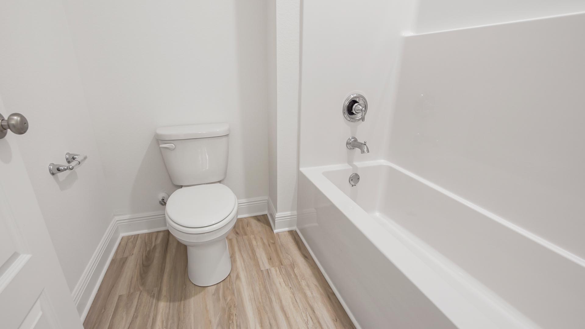 The shower and tub have a privacy door in the shared bathroom
