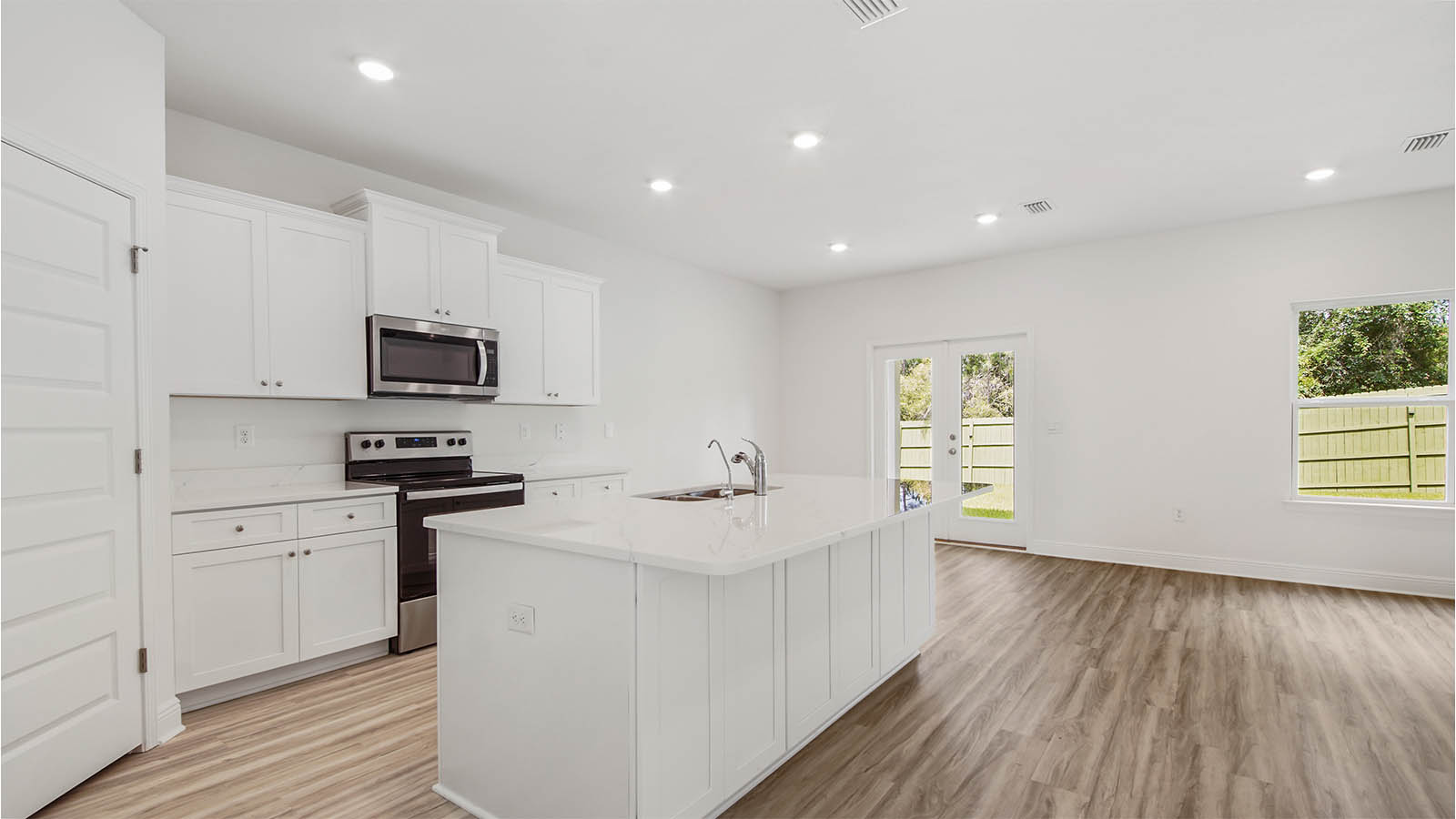 Dining area next to double glass back doors.