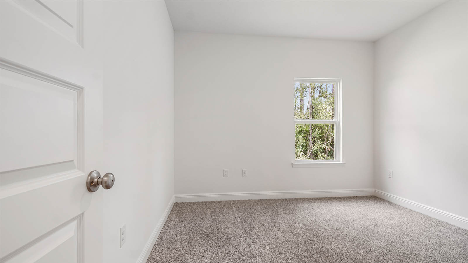 Bedroom two with carpet and window.