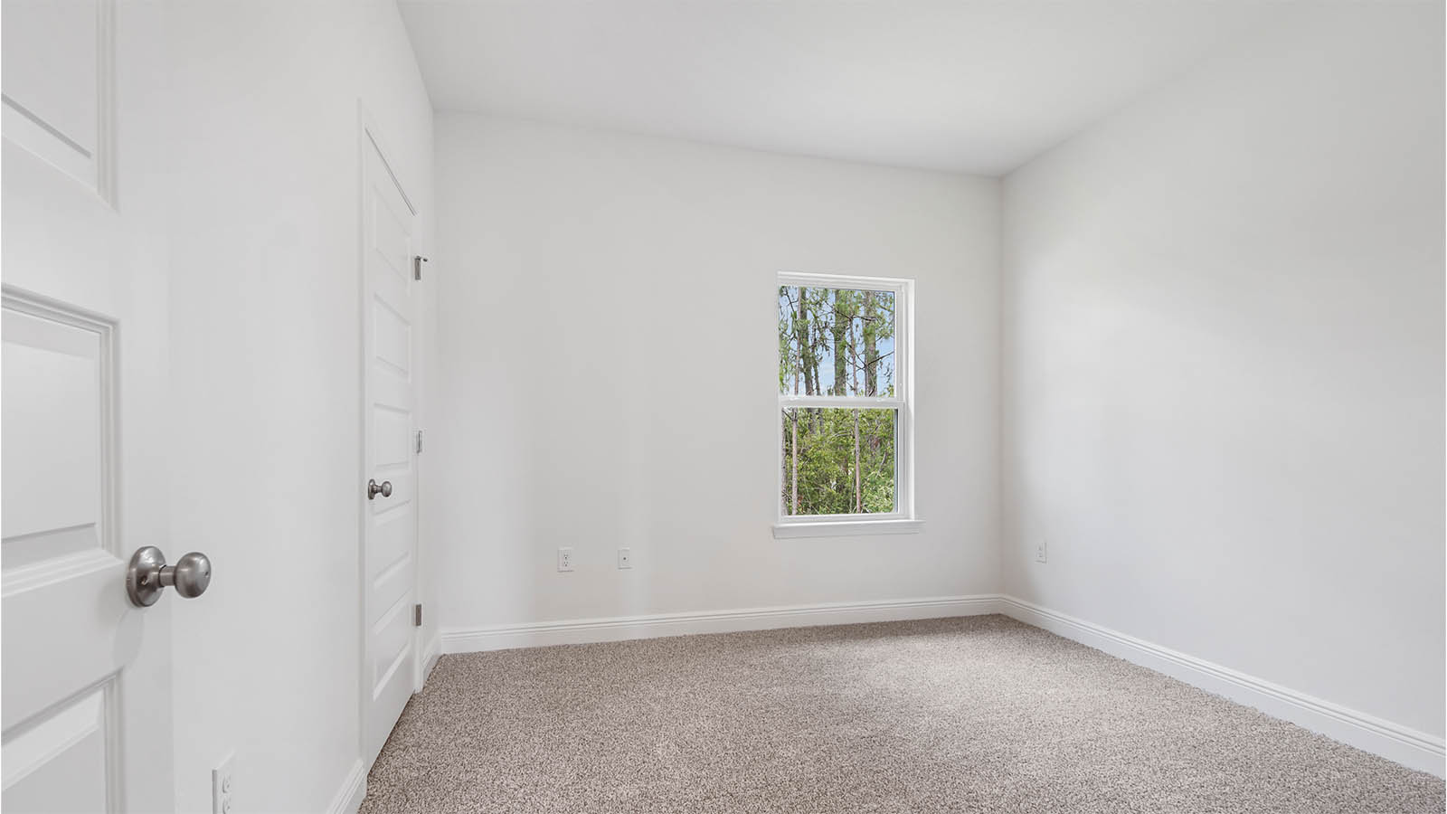 Bedroom three with carpet flooring and window and closet.