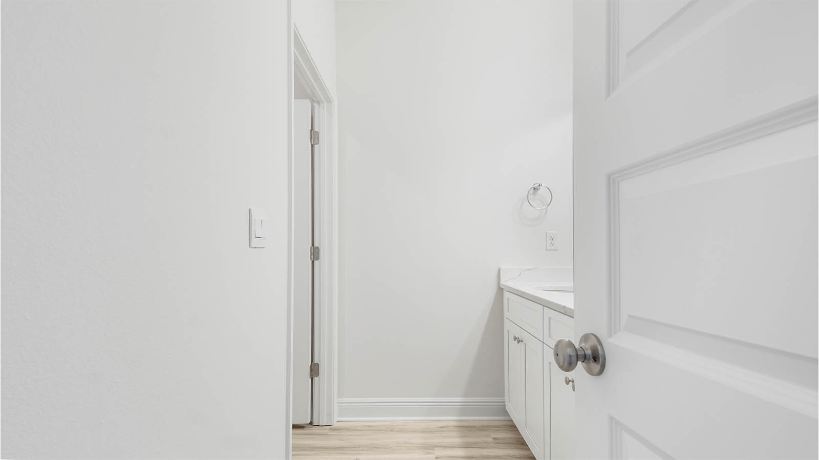 Bathroom three with EVP flooring and quartz countertops.