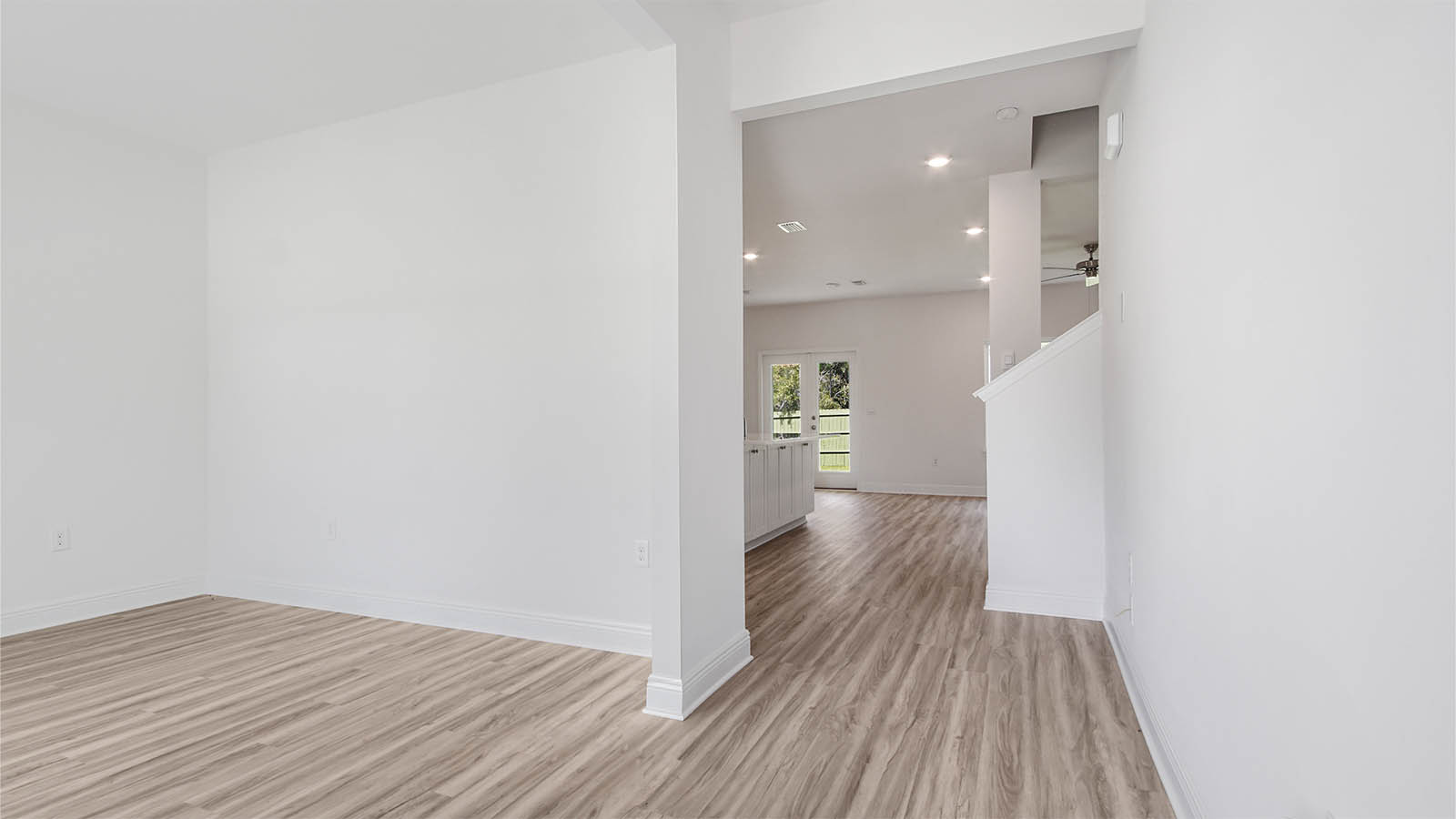 Foyer next to dining room with EVP flooring and windows.